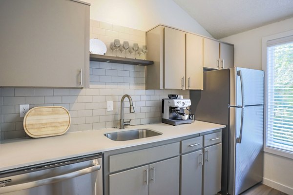 Modern kitchen with stainless steel appliances and granite countertops at Larkspur West Linn Apartments