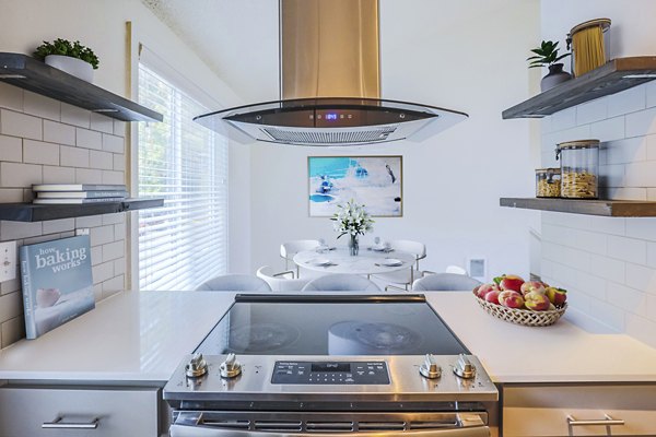 Modern kitchen with stainless steel appliances at Larkspur West Linn Apartments featuring sleek countertops and elegant lighting