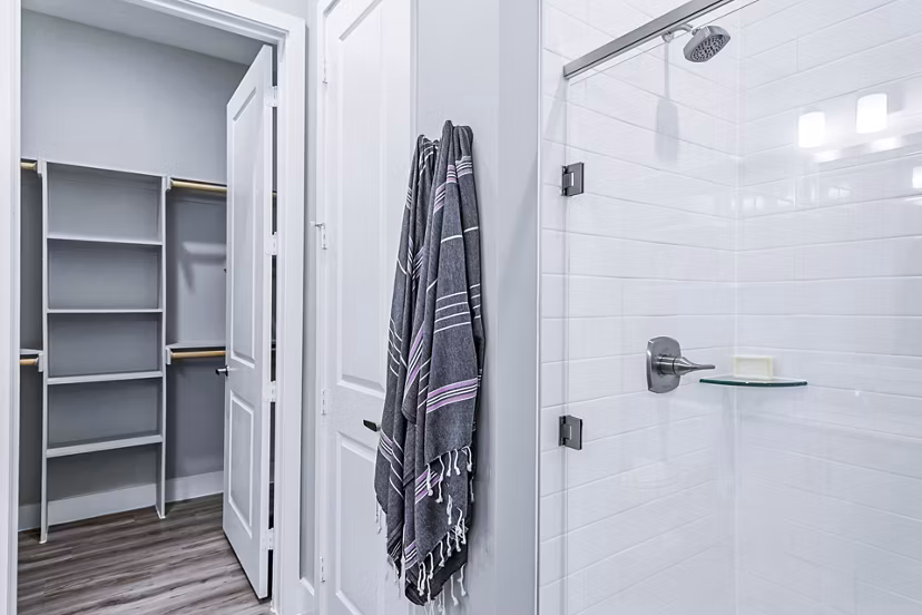 Luxurious bathroom with marble countertops and modern fixtures at The Gin Mill Apartments