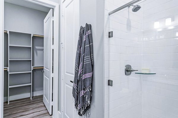 Luxurious bathroom with marble countertops and modern fixtures at The Gin Mill Apartments