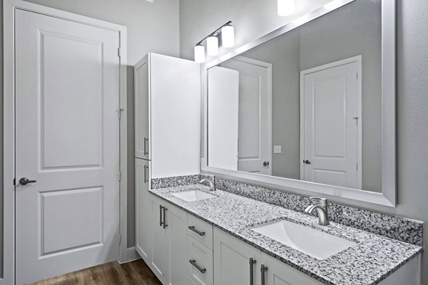 Bathroom featuring modern fixtures and elegant lighting at The Gin Mill Apartments: luxury living spaces