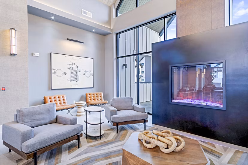 Clubhouse with modern decor and games at The Gin Mill Apartments
