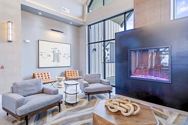 Clubhouse with modern decor and games at The Gin Mill Apartments
