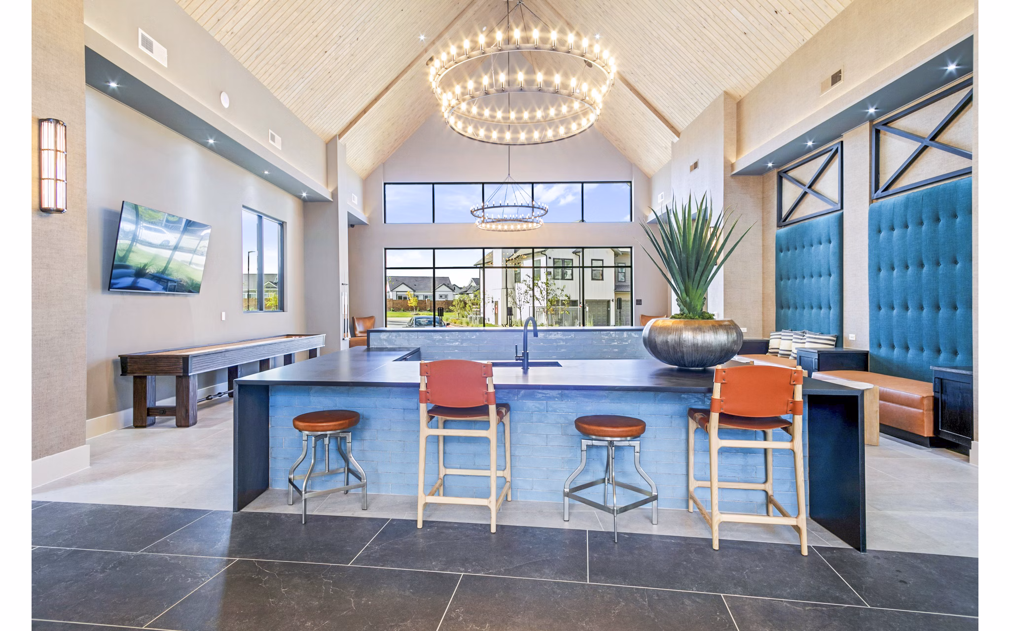 Clubhouse at The Gin Mill Apartments with modern seating and pool table, ideal for social gatherings and entertainment
