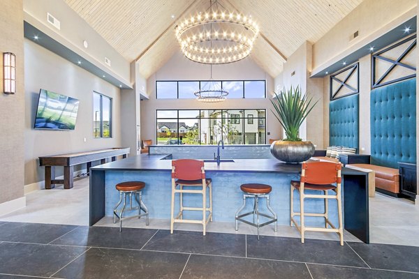 Clubhouse at The Gin Mill Apartments with modern seating and pool table, ideal for social gatherings and entertainment