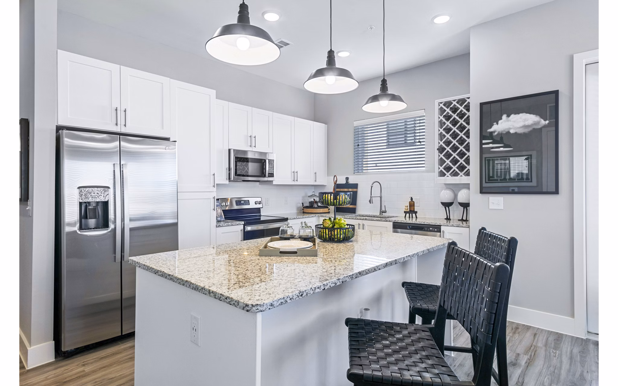 Modern kitchen with stainless steel appliances at The Gin Mill Apartments, a luxury property by Greystar