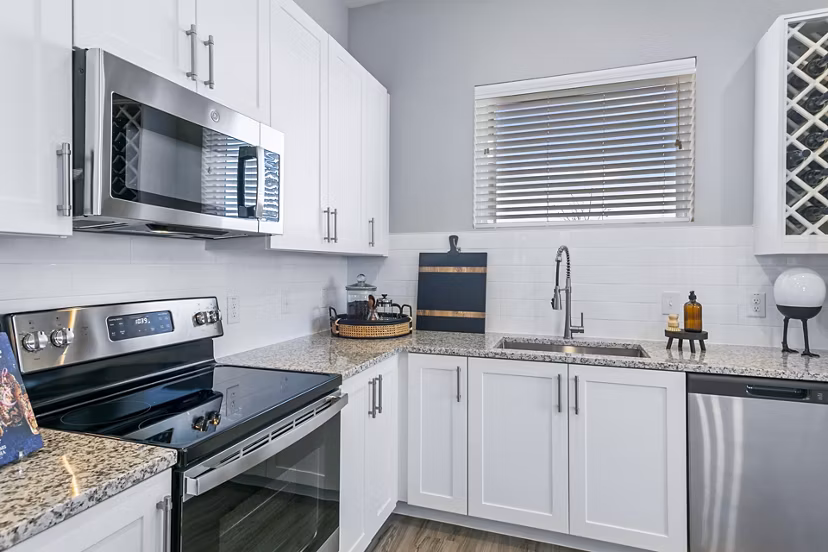Modern kitchen with stainless steel appliances at The Gin Mill Apartments