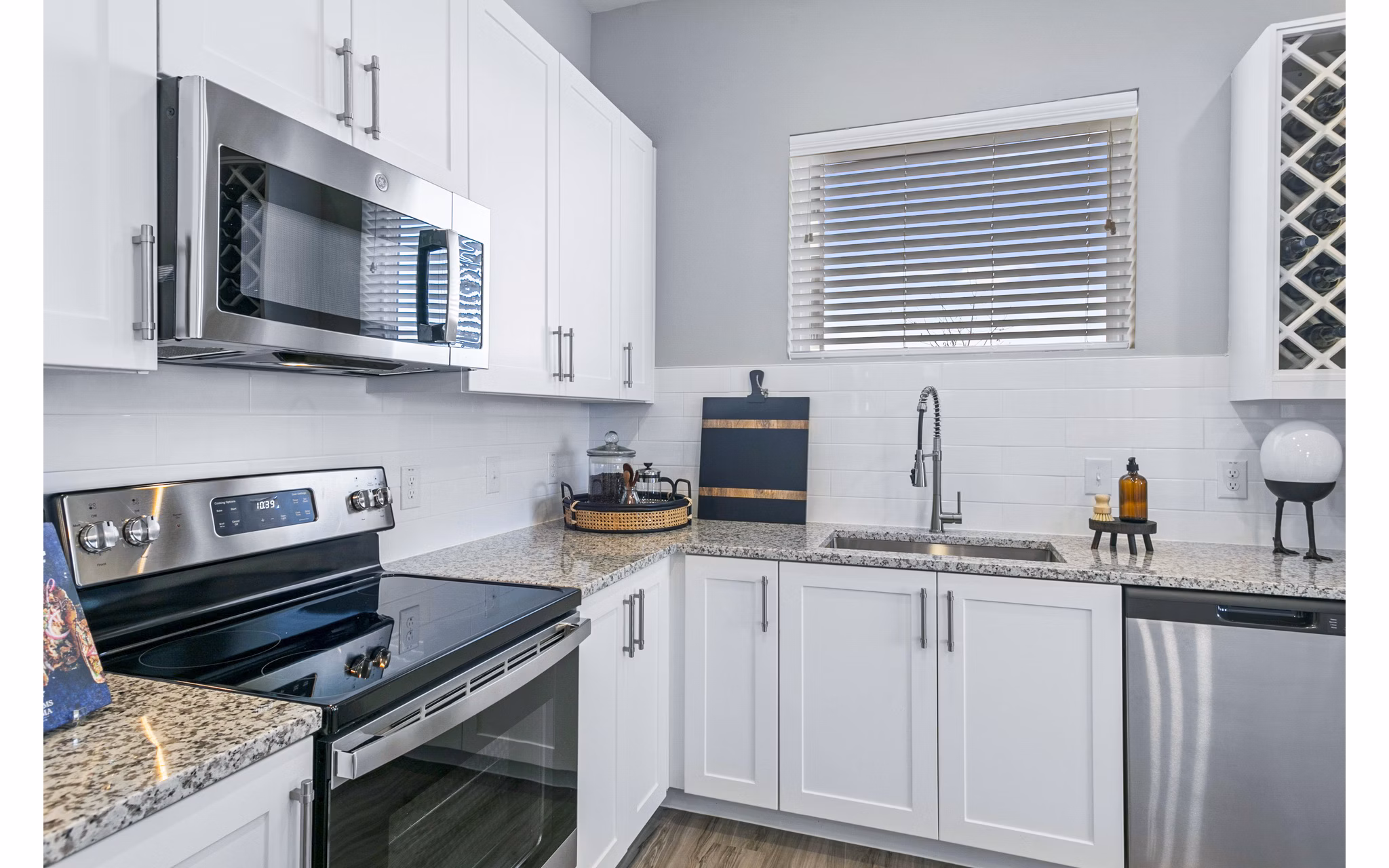 Modern kitchen with stainless steel appliances at The Gin Mill Apartments