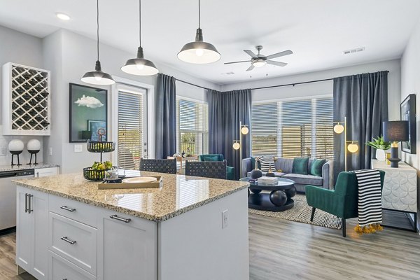 Modern kitchen with stainless steel appliances in The Gin Mill Apartments