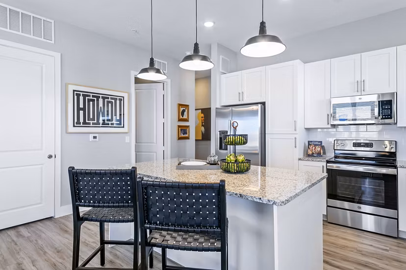 Elegant kitchen with modern appliances and sleek countertops at The Gin Mill Apartments, perfect for luxury living in a stylish setting