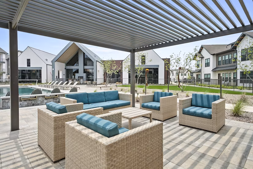 Inviting pool patio with lounge chairs at The Gin Mill Apartments, ideal for relaxation and socializing in luxury apartment living
