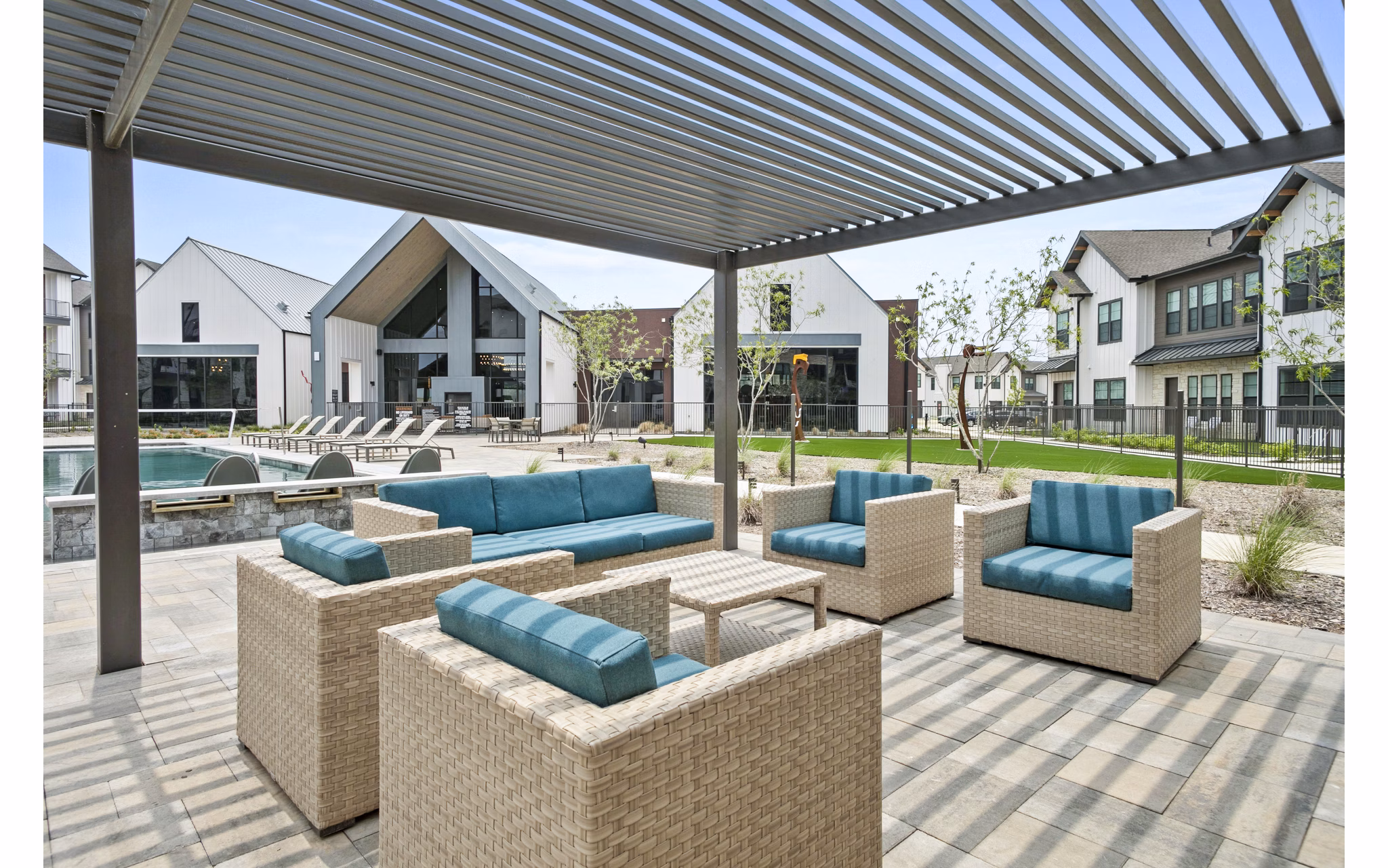 Inviting pool patio with lounge chairs at The Gin Mill Apartments, ideal for relaxation and socializing in luxury apartment living
