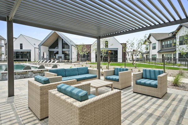 Inviting pool patio with lounge chairs at The Gin Mill Apartments, ideal for relaxation and socializing in luxury apartment living