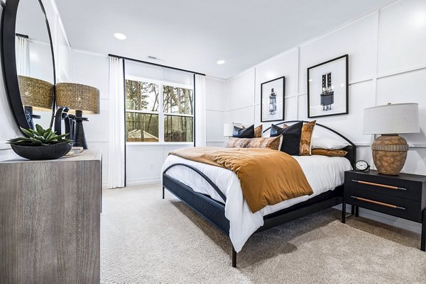 Contemporary bedroom with stylish decor and large windows at Abode Kerr Ridge Apartments luxury living