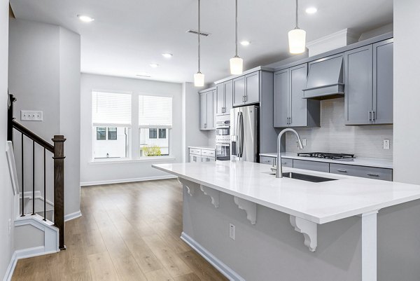 Modern kitchen with stainless steel appliances at Abode Kerr Ridge Apartments