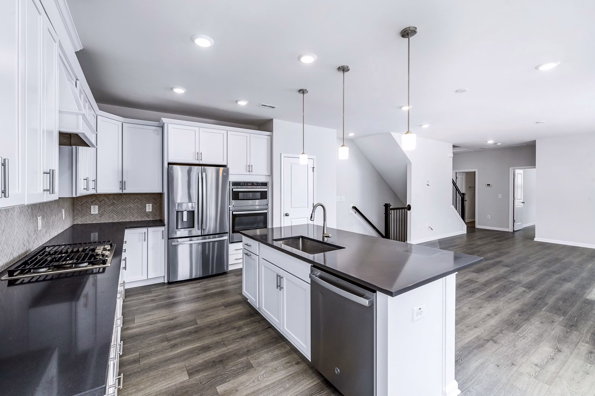 Modern kitchen with stainless steel appliances at Abode Kerr Ridge Apartments