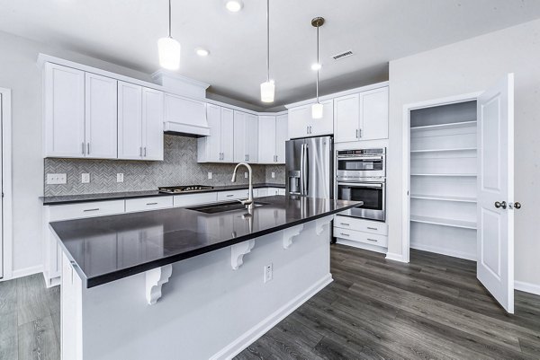 Modern kitchen with stainless steel appliances at Abode Kerr Ridge Apartments, offering luxury living spaces