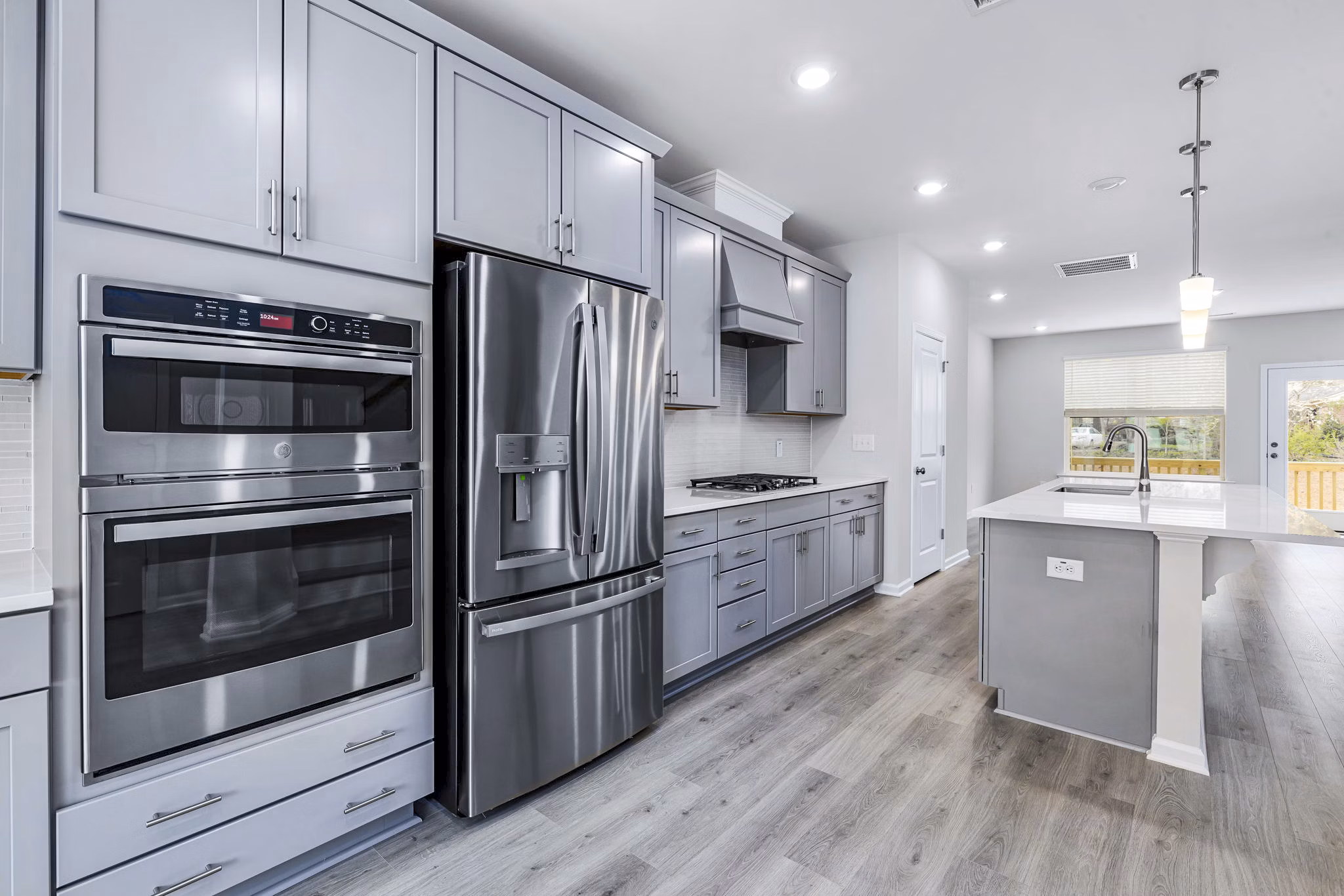 Modern kitchen with stainless steel appliances at Abode Kerr Ridge Apartments - Greystar luxury apartments