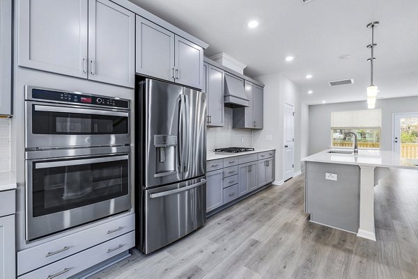 Modern kitchen with stainless steel appliances at Abode Kerr Ridge Apartments - Greystar luxury apartments