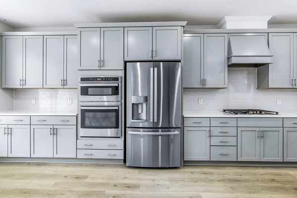 Modern kitchen with stainless steel appliances at Abode Kerr Ridge Apartments, a luxury living option by Greystar