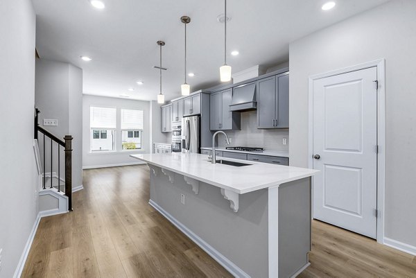 Modern kitchen with sleek cabinetry and stainless appliances at Abode Kerr Ridge Apartments, luxury living by Greystar