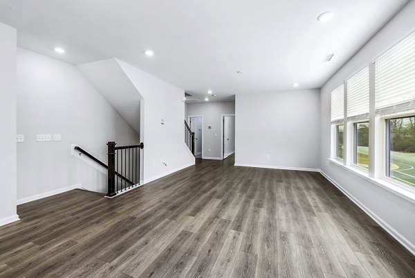 Stairway leading to a modern living room at Abode Kerr Ridge Apartments, luxury apartments by Greystar in a prime location