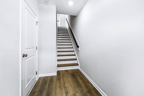 Elegant hallway with modern lighting and sleek stairway at Abode Kerr Ridge Apartments luxury living