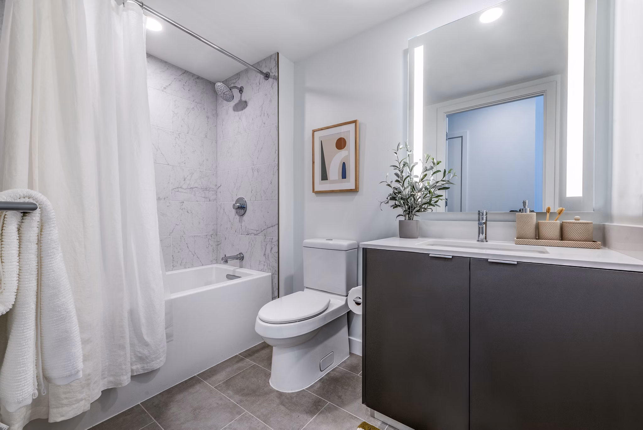 Modern bathroom featuring a sleek bathtub and stylish shower in luxury apartments