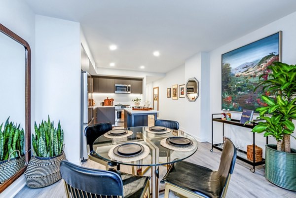 Contemporary dining area with a glass table and stylish chairs in luxury apartments