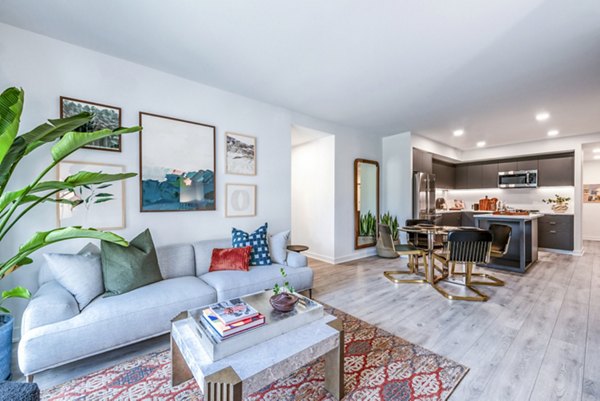 Spacious living room and kitchen with modern decor and stylish furnishings in luxury apartments