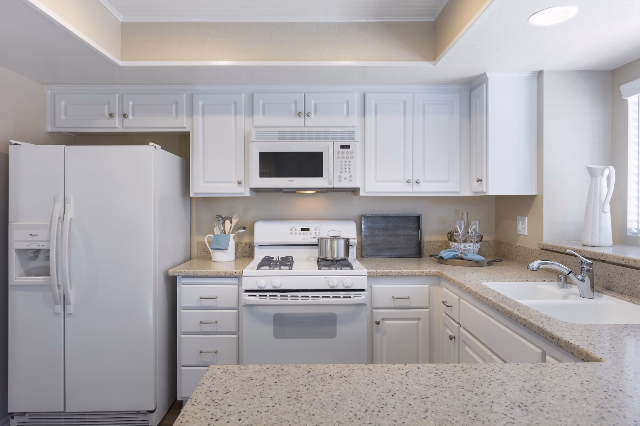 Modern kitchen with stainless steel appliances and granite countertops in Barcelona Apartments