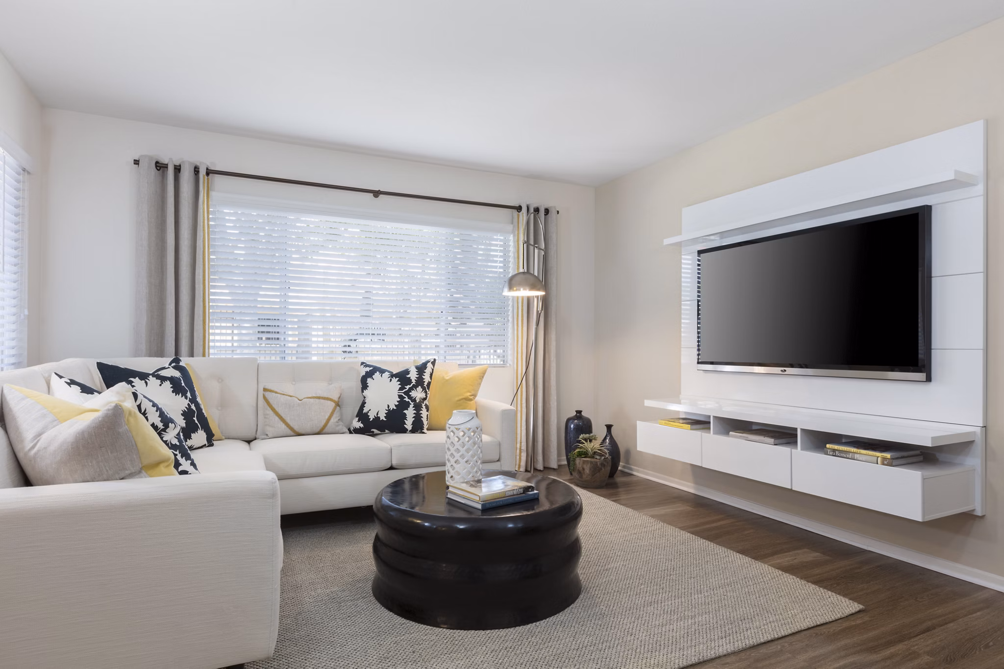 Living room adorned with contemporary furniture and natural light at Barcelona Apartments, offering a comfortable luxury lifestyle