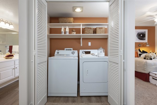 Modern laundry room with stainless steel appliances at Barcelona Apartments, offering convenience for residents in premium luxury living