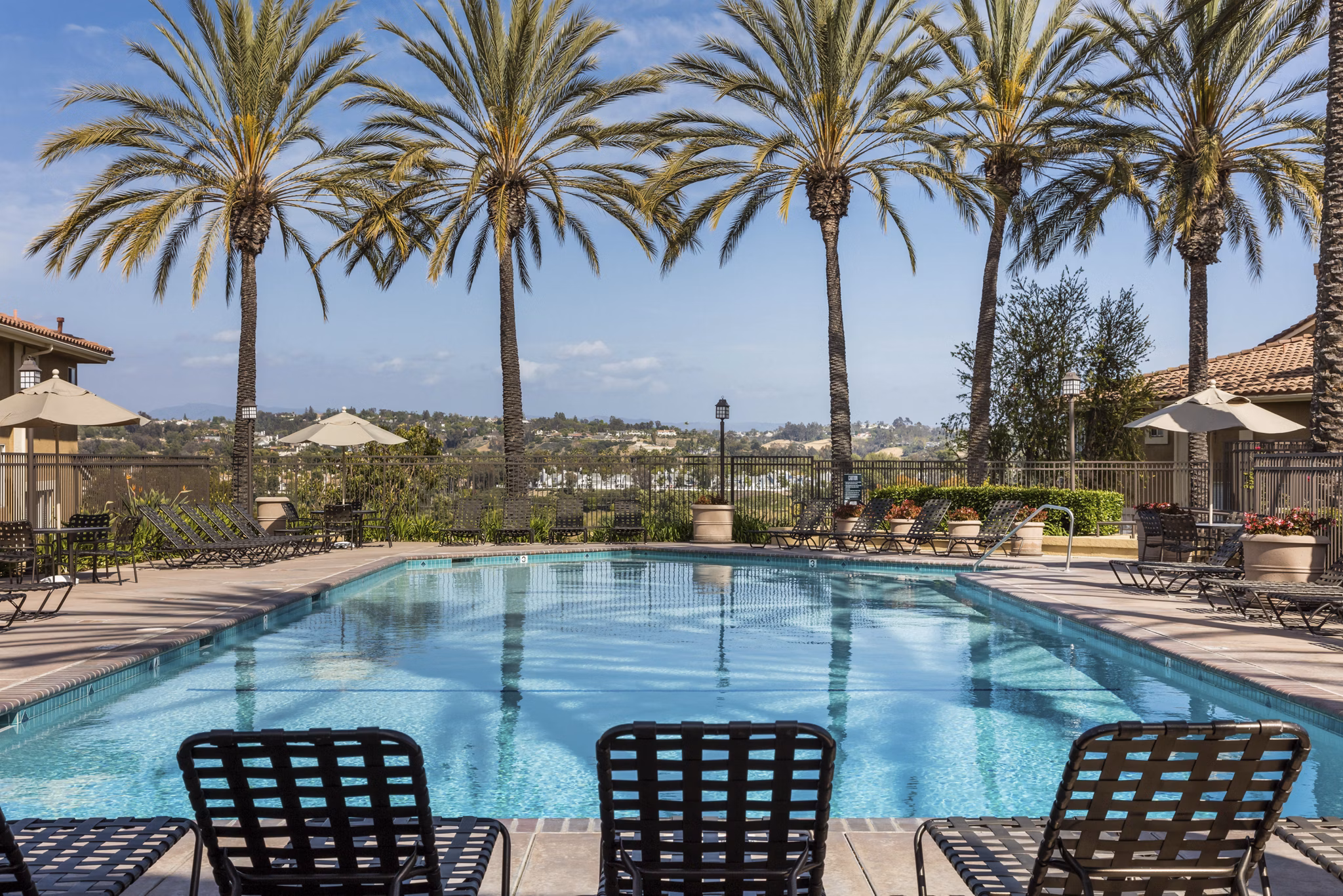 Barcelona Apartments: stylish pool area with modern seating and lush landscaping, ideal for relaxation and leisure