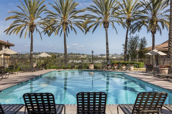 Barcelona Apartments: stylish pool area with modern seating and lush landscaping, ideal for relaxation and leisure