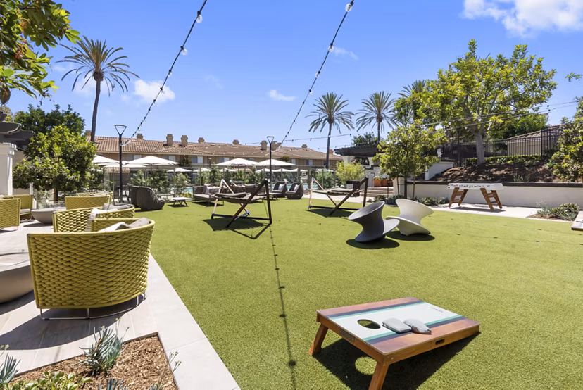 Indoor basketball court with polished hardwood floors at Barcelona Apartments, perfect for recreational play and active living