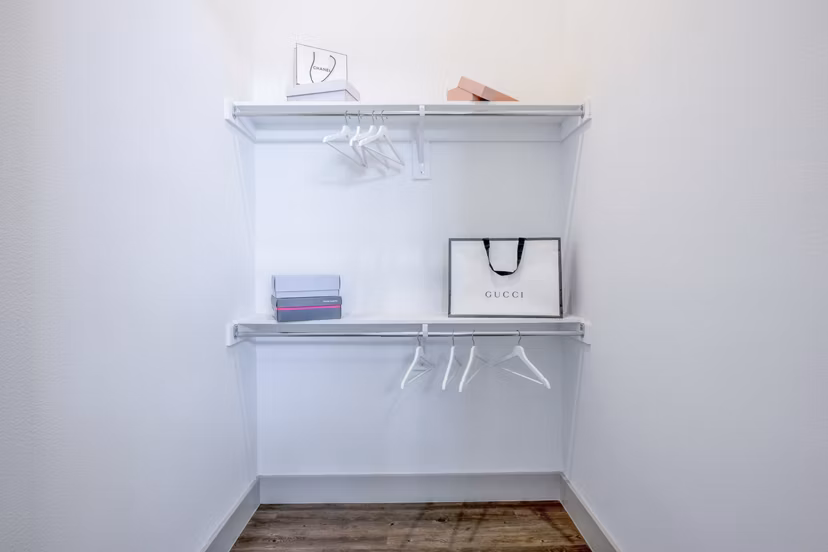 Walk-in closet with custom shelving in The Beverley at Denton Apartments