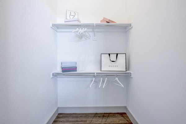 Walk-in closet with custom shelving in The Beverley at Denton Apartments