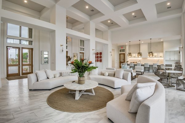 Clubhouse featuring modern design and cozy seating at The Mark at Denton Apartments