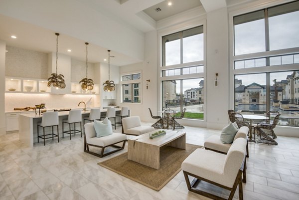 Clubhouse featuring modern design and spacious seating at The Mark at Denton Apartments