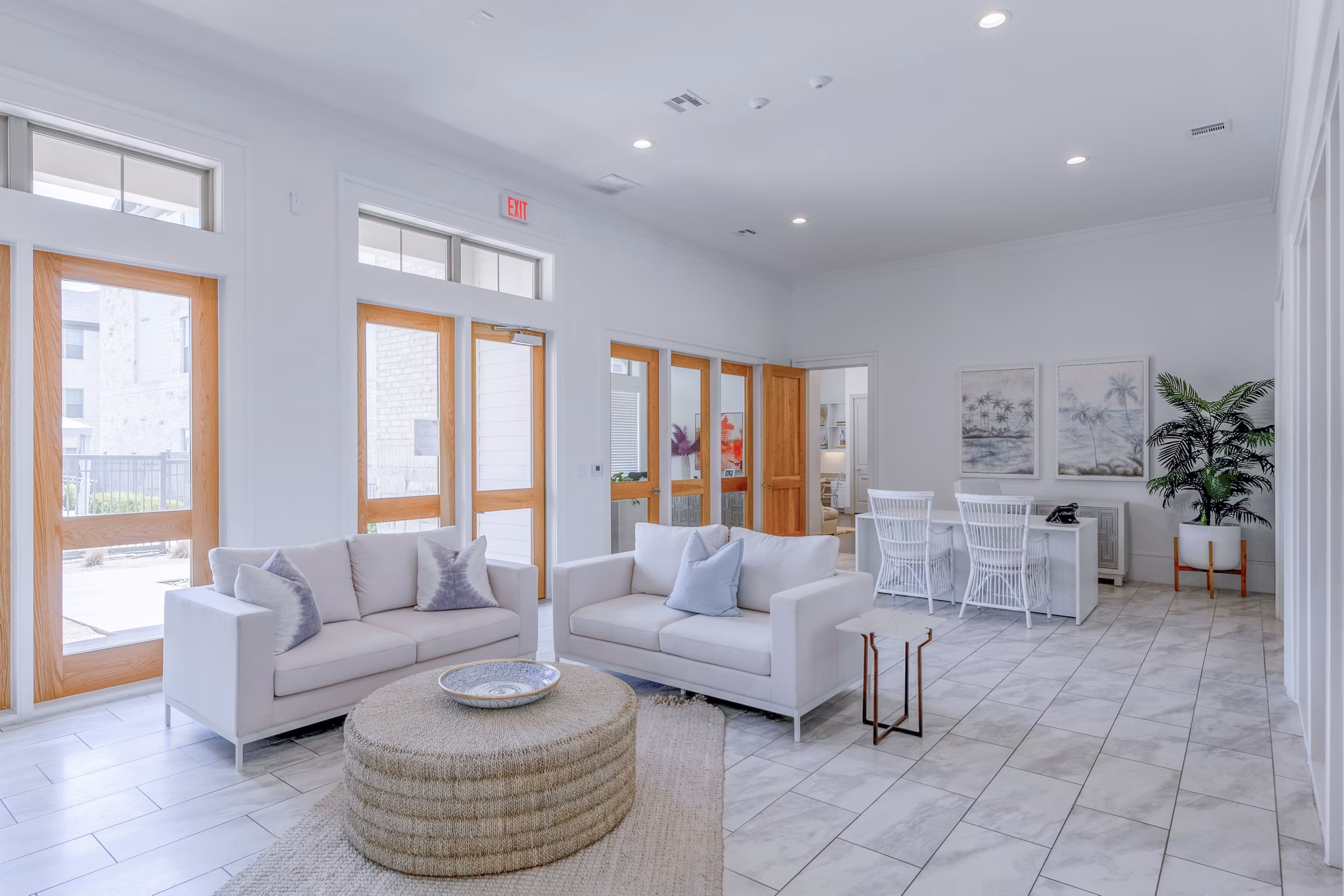 Modern clubhouse featuring cozy seating and game tables at The Mark at Denton Apartments