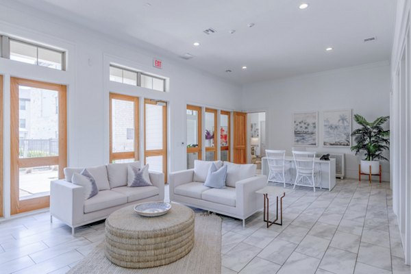 Modern clubhouse featuring cozy seating and game tables at The Mark at Denton Apartments