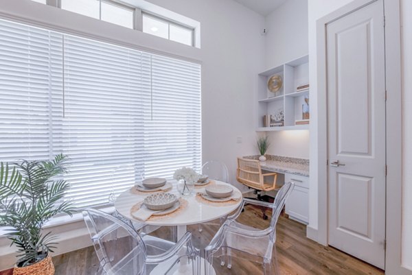 Dining area with modern furnishings in The Beverley at Denton Apartments, showcasing elegance and comfort for residents