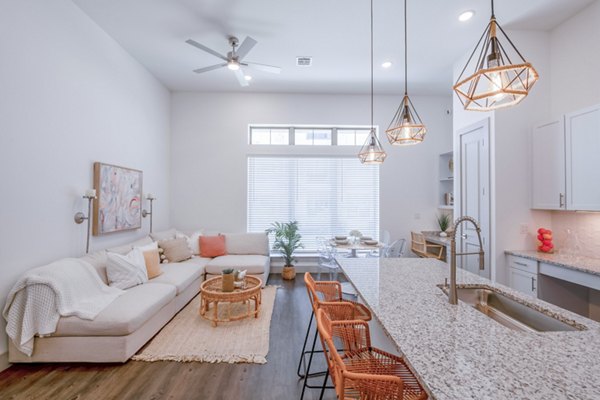 Modern kitchen with stainless steel appliances in The Beverley at Denton Apartments