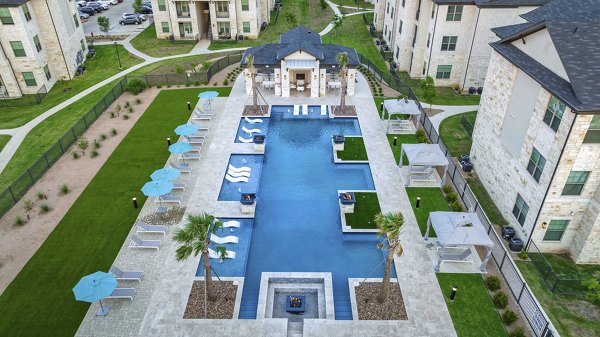 Resort-style pool with sun deck at The Mark at Denton Apartments offering luxury amenities for relaxation and leisure