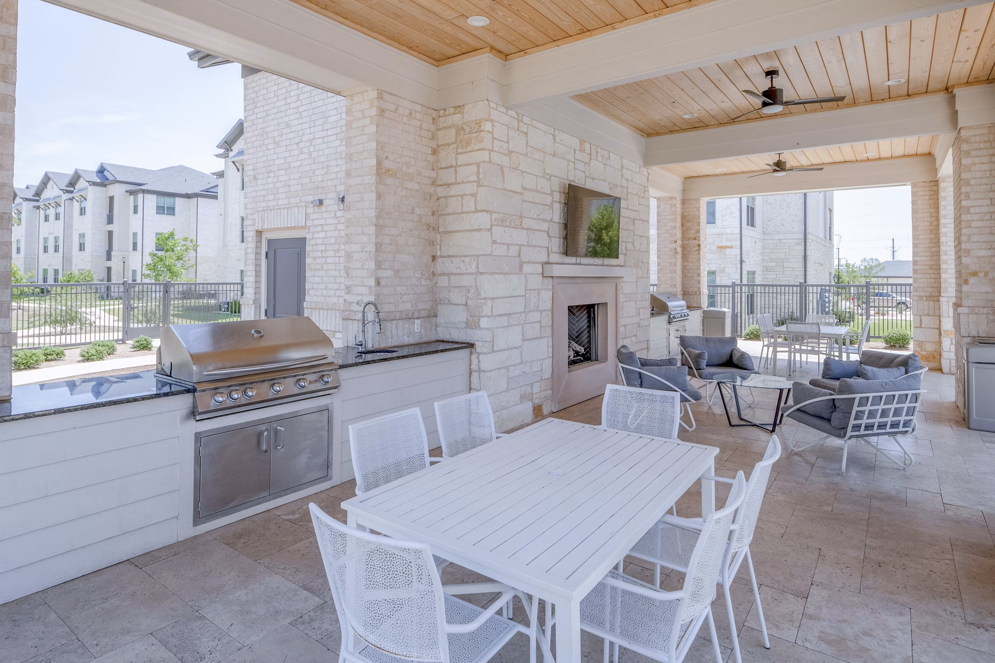 Grill area with seating at The Mark at Denton Apartments, ideal for outdoor gatherings and relaxation