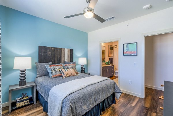 Cozy bedroom with modern decor at Prose Northbend Apartments, featuring luxurious furnishings and ambient lighting