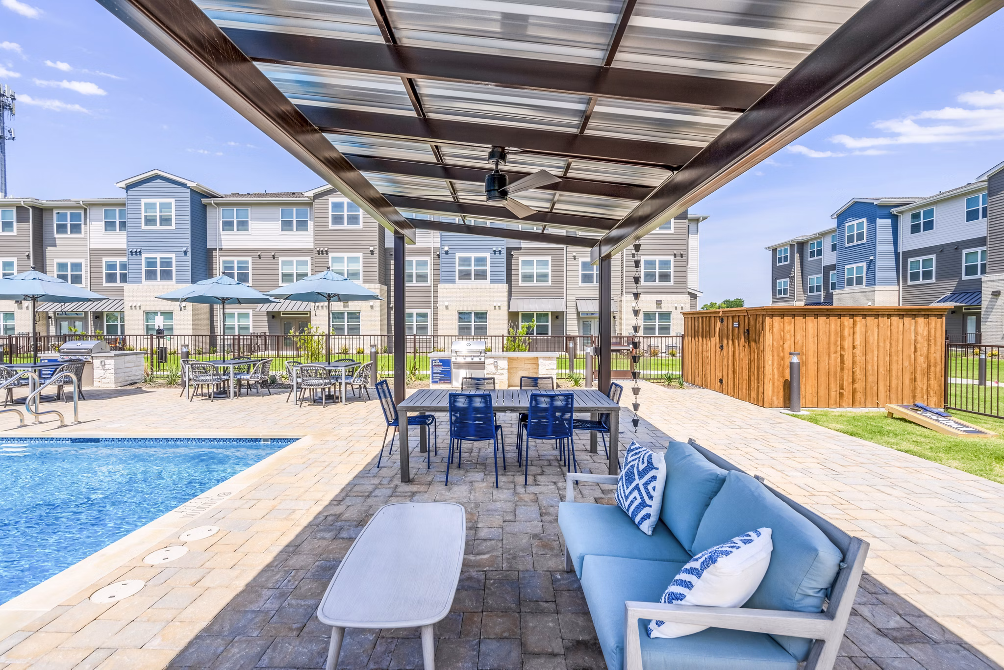 Outdoor pool with cozy patio seating at Prose Northbend Apartments