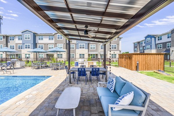 Outdoor pool with cozy patio seating at Prose Northbend Apartments