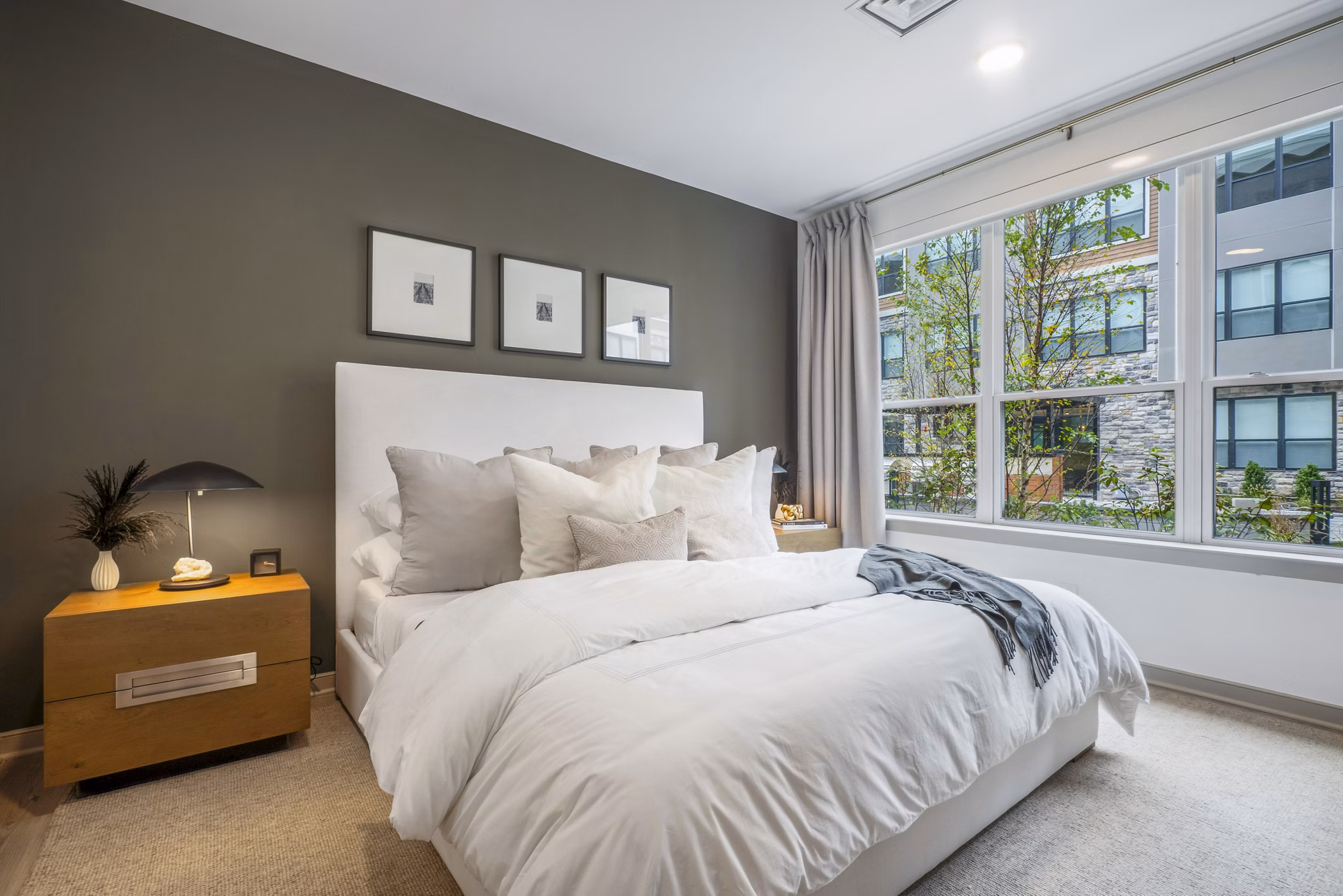 Bedroom with modern decor and natural light at Enclave at Raritan Apartments â€“ luxury living by Greystar